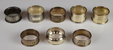 Eight various hallmarked silver napkin rings including a heavy engine turned example and a pair,