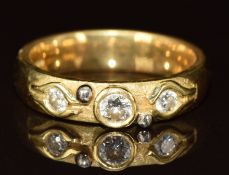 An 18ct gold ring set with three diamonds of approximately 0.12ct, 0.06ct & 0.06ct, 5.9g, size L