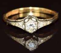 An 18ct gold ring set with a diamond of approximately 0.14ct and further diamonds to the shoulders