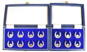 Set of fourteen modern novelty hallmarked silver place card holders formed as horseshoes, Birmingham