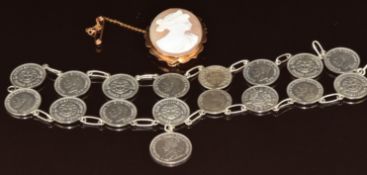 A 9ct gold brooch set with a cameo depicting a young woman (5.6g, 3.3 x 2.6cm) and a coin bracelet