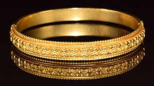 Victorian yellow metal bangle with embossed floral decoration, 10.6g, 4.8 x 5.5cm