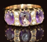 A 9ct gold ring set with amethysts and paste, 4.8g, size O