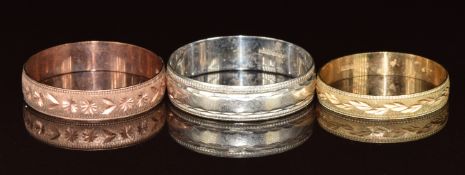 Three 9ct gold wedding bands / rings, one white gold, one rose gold and the other yellow gold, 6.2g,