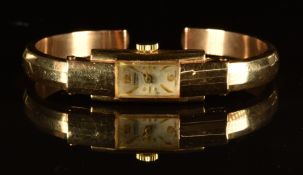 Verbena 18ct gold ladies bangle wristwatch with gold hands and hour markers, silver dial and 17
