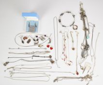 A collection of silver jewellery including peridot pendant, fourteen chains, eleven pendants, nine