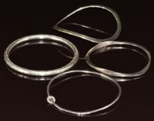 Four silver bangles, one Gusterman's sterling Georgetown, 52g