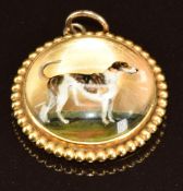 A yellow metal c1900 pendant set with a reverse painted Essex crystal cabochon depicting a dog, 5.