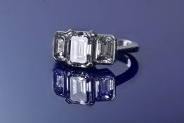Theo Fennell platinum ring set with an emerald cut diamond of approximately 1.52ct flanked by two