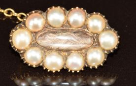 Victorian brooch set with split pearls and a glass compartment to the centre set with plaited