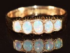 A 15ct gold ring set with five opal cabochons, Chester 1911, 2.1g, size N