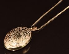 A 9ct gold locket with scrolling decoration, on 9ct gold chain, 9.1g, 44cm, 4cm