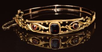 A c1900 9ct gold bangle set with garnets, 8g