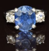 A platinum ring set with an oval cut synthetic sapphire of approximately 5.3ct and two round cut