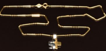 An 18ct bi-coloured gold cross set with two diamonds, on 18ct gold chain, 9.3g, 2cm, 44cm