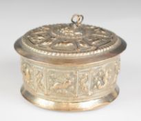 Burmese or similar silver trinket pot embossed with panels of animals to the side and lid and a