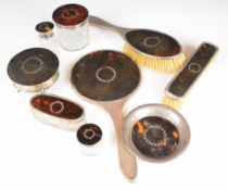 Nine hallmarked silver mounted tortoiseshell dressing table items, various dates and makers, many