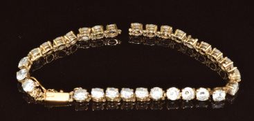A 9ct gold bracelet set with cubic zirconia (one link needs repair), 10.7g, 17.5cm
