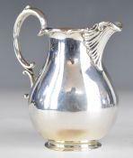 Victorian hallmarked silver milk jug with wavy edge and scroll handle, London, date letter rubbed,