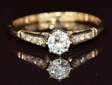 A 9ct gold ring set with a diamond of approximately 0.25ct, with diamond encrusted shoulders, 1.