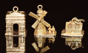 Three 9ct gold charms including windmill, Arc De Triomphe and house, 6.3g