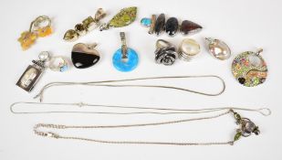 A collection of silver jewellery including three rings and ten pendants, 158g