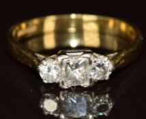 An 18ct gold ring set with a princess cut diamond of approximately 0.25ct and two round cut