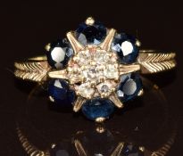 An 18ct gold ring set with a cluster of diamonds surrounded by round cut sapphires, 3.2g, size R