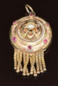 Victorian yellow metal pendant set with a split pearl and rubies, verso a locket compartment with