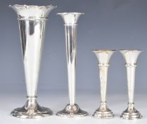 Three hallmarked silver flared vases and one marked sterling, only the latter filled, tallest