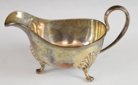 George V hallmarked silver sauce boat with reeded edge, raised on three paw feet, Sheffield 1929,
