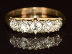 An 18ct gold ring set with five diamonds, the largest approximately 0.15ct, 3g, size J/K