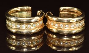 A pair of 9ct gold earrings each set with ten round cut diamonds totalling approximately 0.8ct, 10.