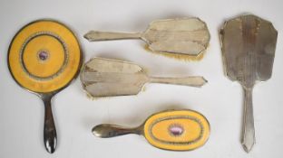 Art Deco hallmarked silver hand mirror and two brushes together with a silver plated hand mirror and