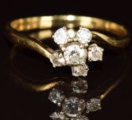An 18ct gold ring set with diamonds in a cluster, the centre diamond approximately 0.15ct, 2.9g (