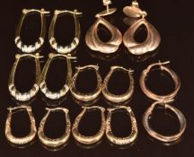 Seven pairs of 9ct gold hoop earrings including bi-coloured and pairs with engraved decoration, 10.