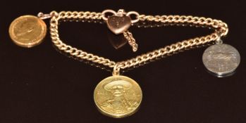 A 9ct gold charm bracelet with two gilt coin charms, a silver 'Aix-Les-Bains' charm and heart