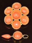 An 18k gold brooch set with coral within a rope twist border (3.4cm) and a matching pendant, 3cm,