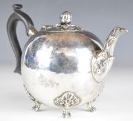 Victorian hallmarked silver bullet shaped teapot with carved wooden scrolling handle and raised on