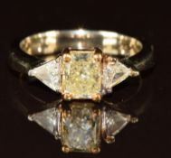 An 18k white gold ring set with a modern rectangular cut yellow diamond of approximately 1.2ct and
