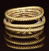 A yellow metal ring made up of five bands, two smooth and three rope twist, 12.1g, size M