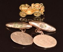 A pair of 9ct rose gold cufflinks and a 9ct gold charm in the form of a car opening to reveal the