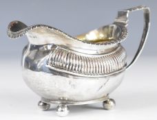 Georgian hallmarked silver milk jug with gadrooned edge, raised on four feet, London 1817, maker's