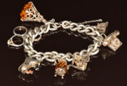 Silver charm bracelet with seven silver charms, one by Nuno, 65.4g, 18.5cm