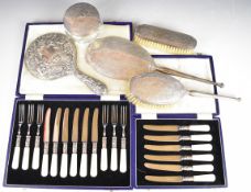 Hallmarked silver mounted dressing table items comprising Mappin & Webb hand mirror and two brushes,
