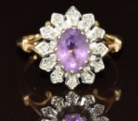 A 9ct gold ring set with an oval cut amethyst and diamonds, 3.6g, size O