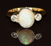 An 18ct gold ring set with an opal cabochon and two diamonds, 2.5g, size N