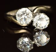 An 18ct white gold ring set with two round brilliant cut diamonds of approximately 0.6ct each, 3.5g,