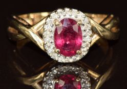 A 9ct gold ring set with an oval cut ruby surrounded by diamonds, 2.8g, size L
