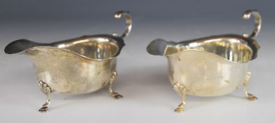 Asprey & Co Ltd pair of hallmarked silver sauce boats, with shaped edges and scroll handles,